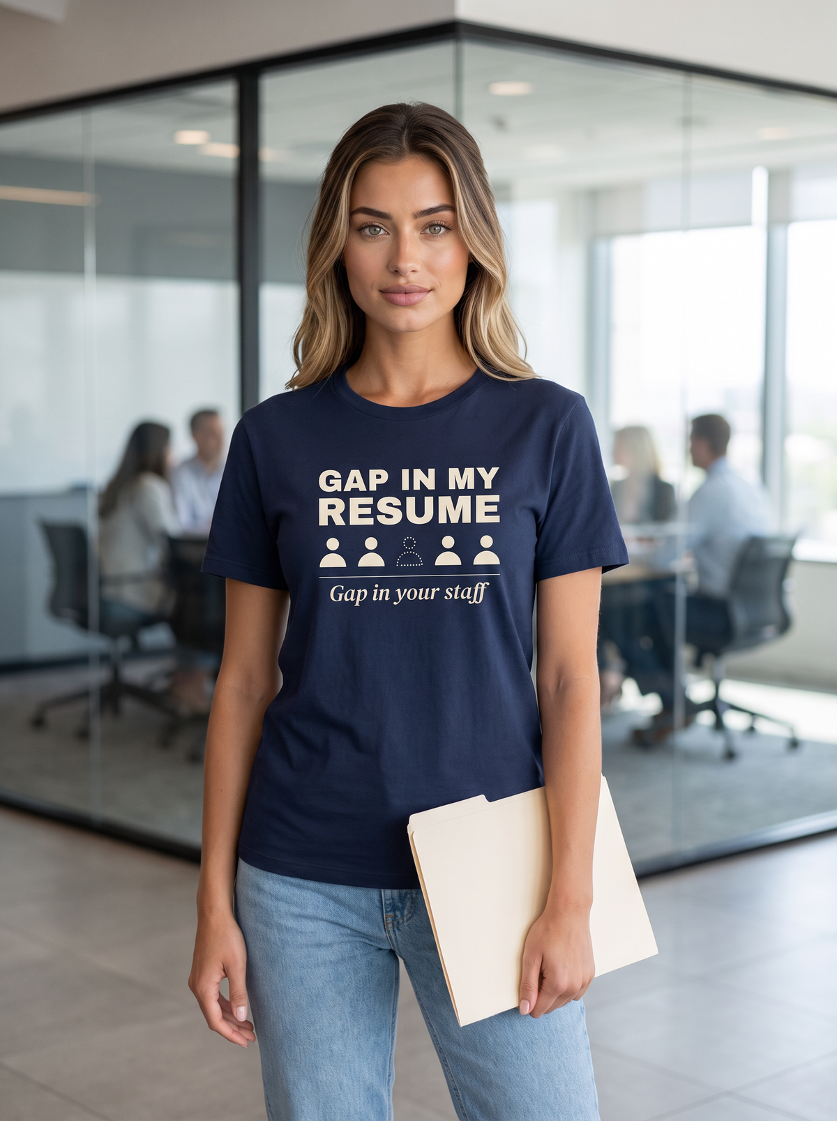 Seloura wearing the unisex t-shirt in navy with a row of five figures with one missing and cream bold type reading gap in my resume, gap in your staff. Model: Seloura (AI brand character). AI-generated model image; the printed design is the actual product artwork.
