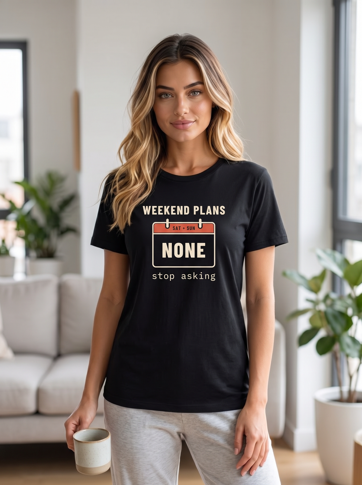Seloura wearing the unisex t-shirt in black with a calendar page for Saturday and Sunday reading none and cream type reading weekend plans, stop asking. Model: Seloura (AI brand character). AI-generated model image; the printed design is the actual product artwork.