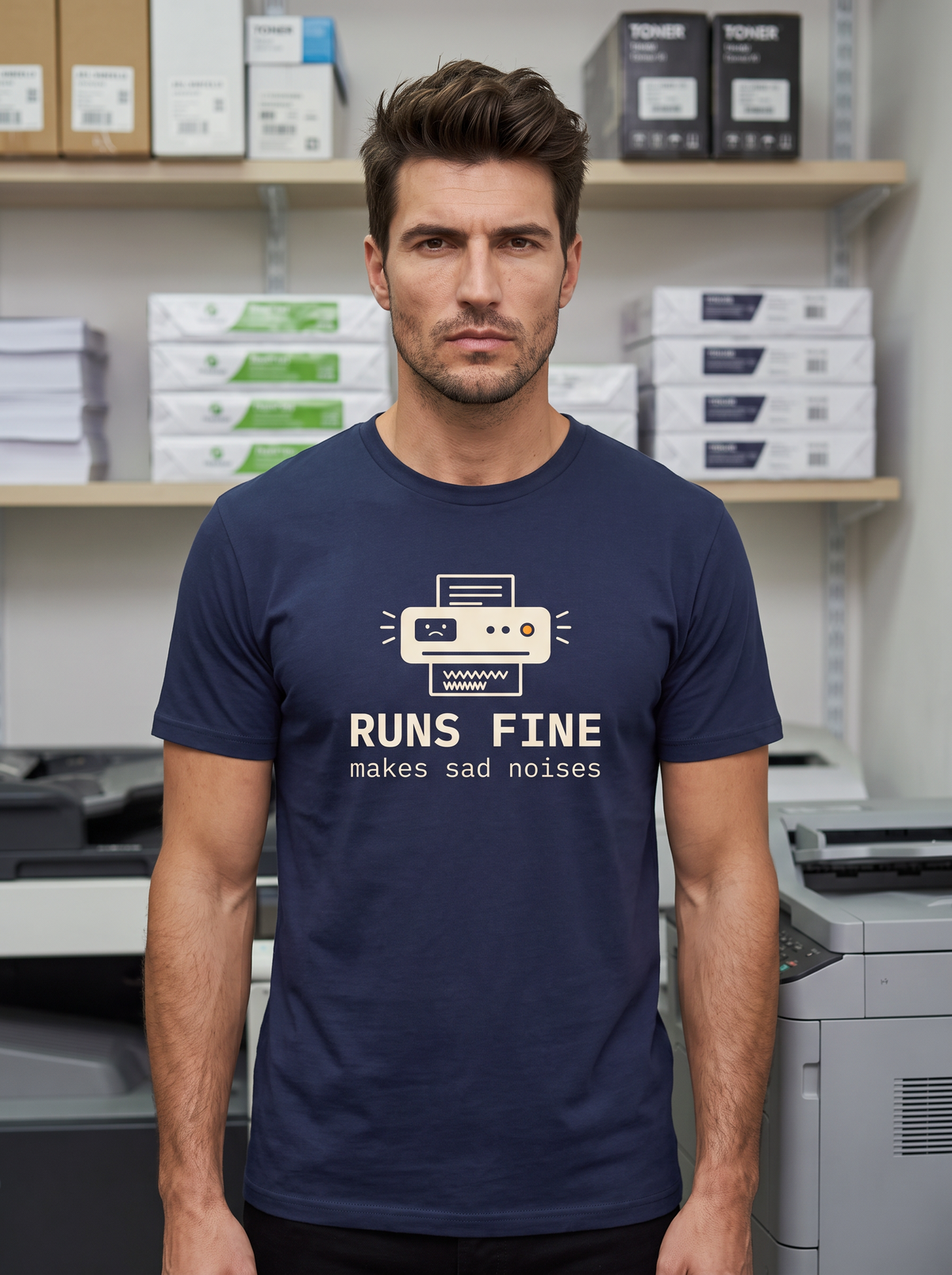 Liora wearing the unisex t-shirt in navy with a drawing of an office printer with a sad face display and monospace type reading runs fine, makes sad noises. Model: Liora (AI brand character). AI-generated model image; the printed design is the actual product artwork.