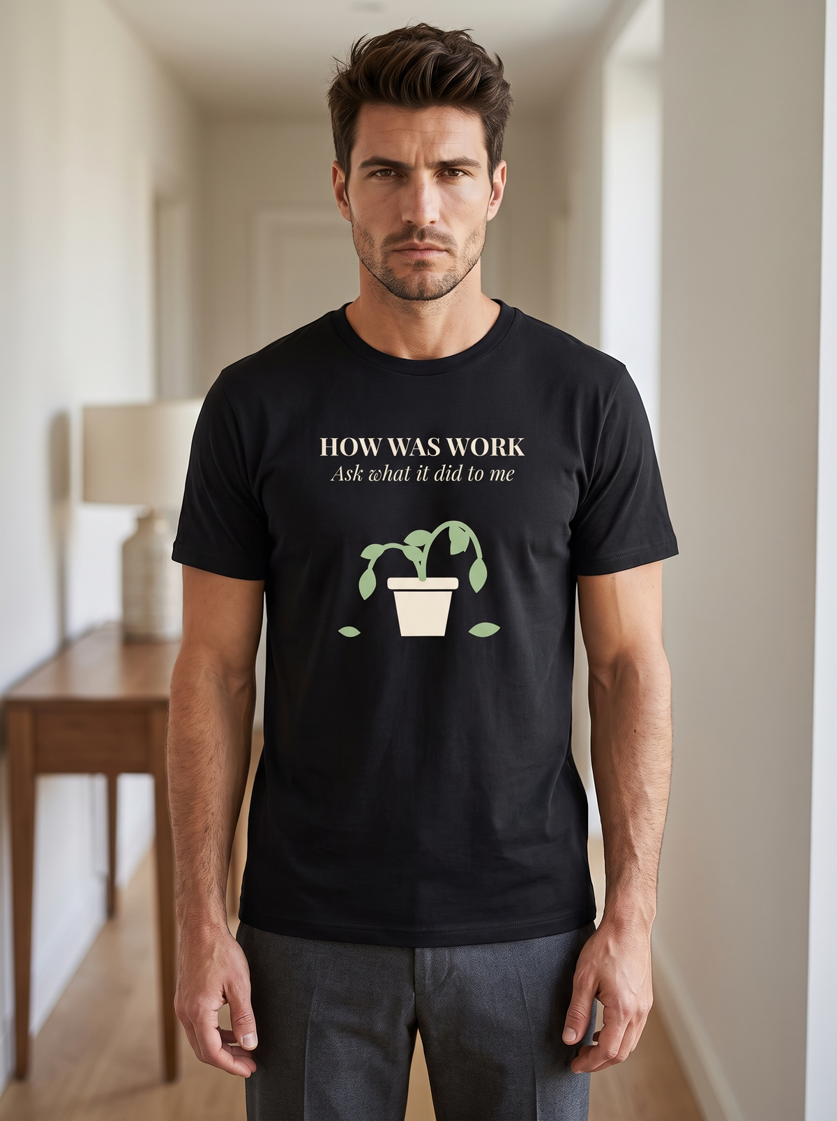 Liora wearing the unisex t-shirt in black with a drawing of a drooping potted plant and cream serif type reading how was work, ask what it did to me. Model: Liora (AI brand character). AI-generated model image; the printed design is the actual product artwork.