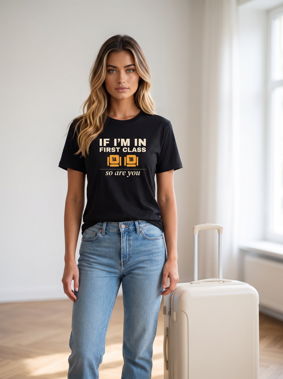 Seloura wearing the unisex t-shirt in black with two wide seats marked 1A and 1B in amber and cream type reading if I'm in first class, so are you. Model: Seloura (AI brand character). AI-generated model image; the printed design is the actual product artwork.
