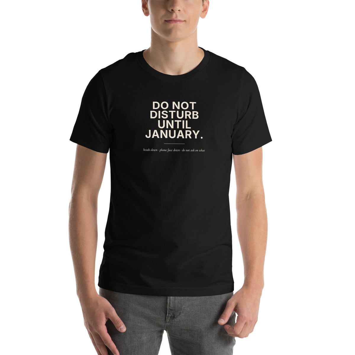 Do Not Disturb Until January unisex t-shirt in black, front view, cream bold print