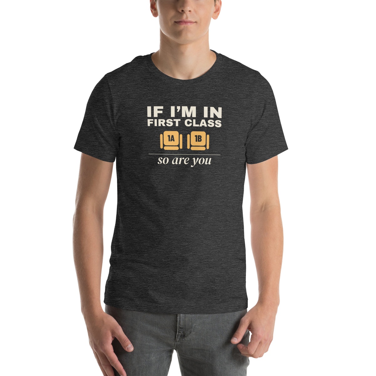 Unisex t-shirt in dark grey heather with two wide seats marked 1A and 1B in amber and cream type reading if I'm in first class, so are you