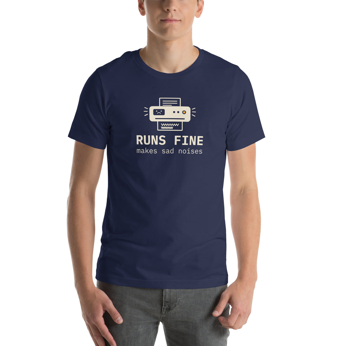 Unisex t-shirt in navy with a drawing of an office printer with a sad face display and monospace type reading runs fine, makes sad noises